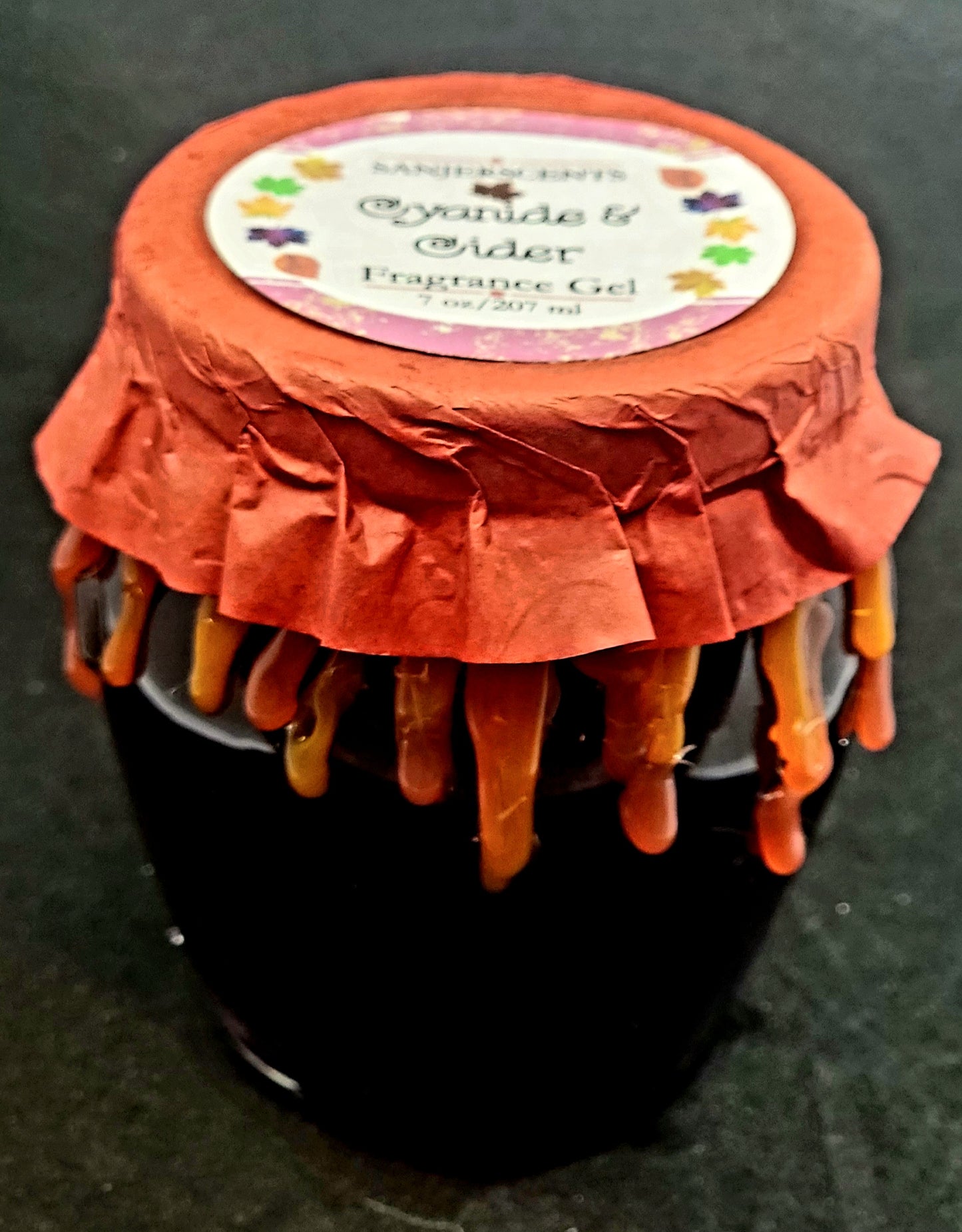 7 oz glass honeypot jar with purple Cyanide & Cider fragrance gel. Metal screw top lid with red cover