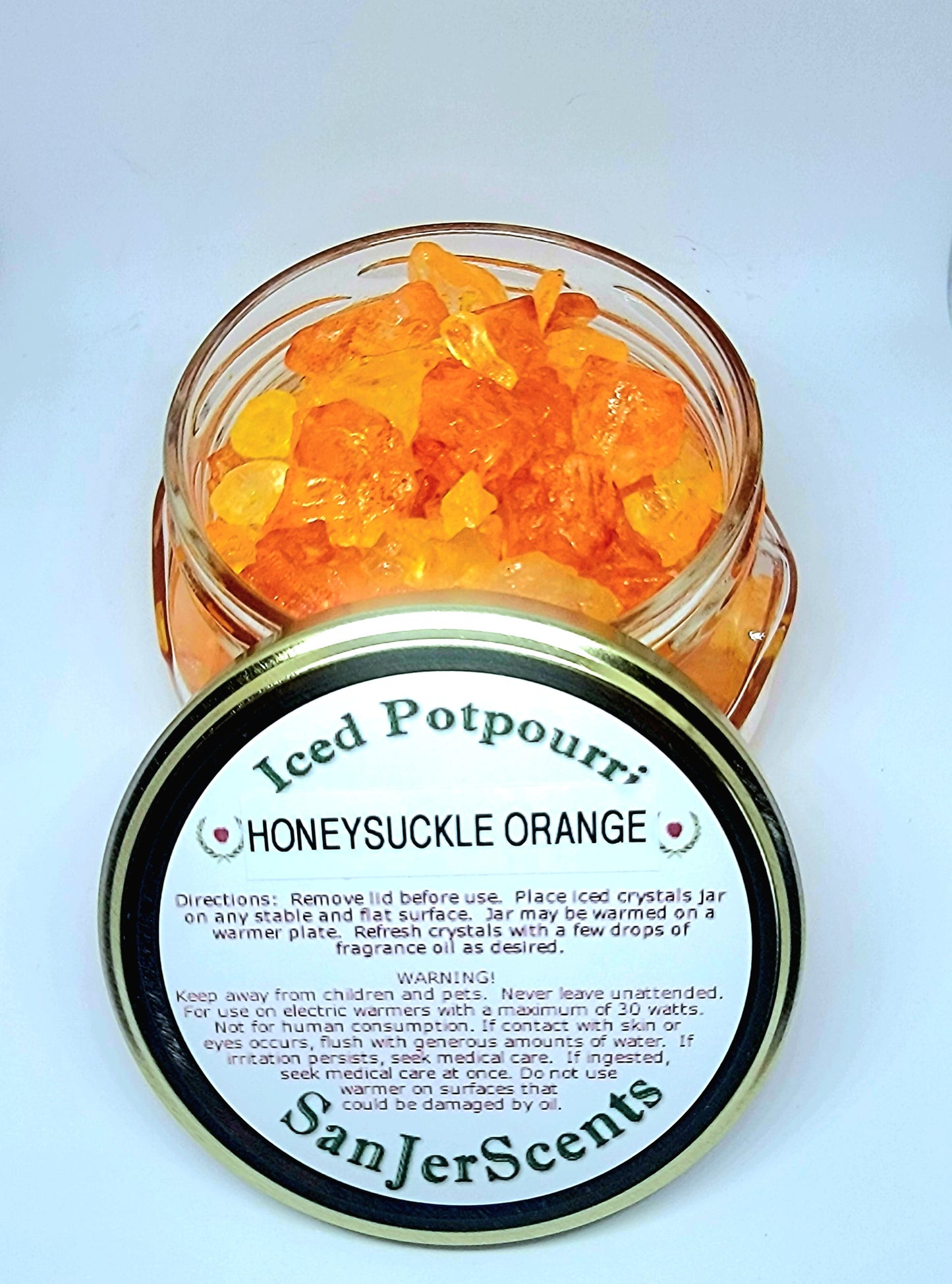 Orange and yellow large rock salt crystal potpourri in glass tureen jar with gold lid.  Honeysuckle Orange scent.