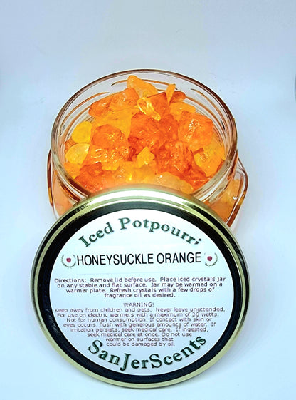 Orange and yellow large rock salt crystal potpourri in glass tureen jar with gold lid.  Honeysuckle Orange scent.