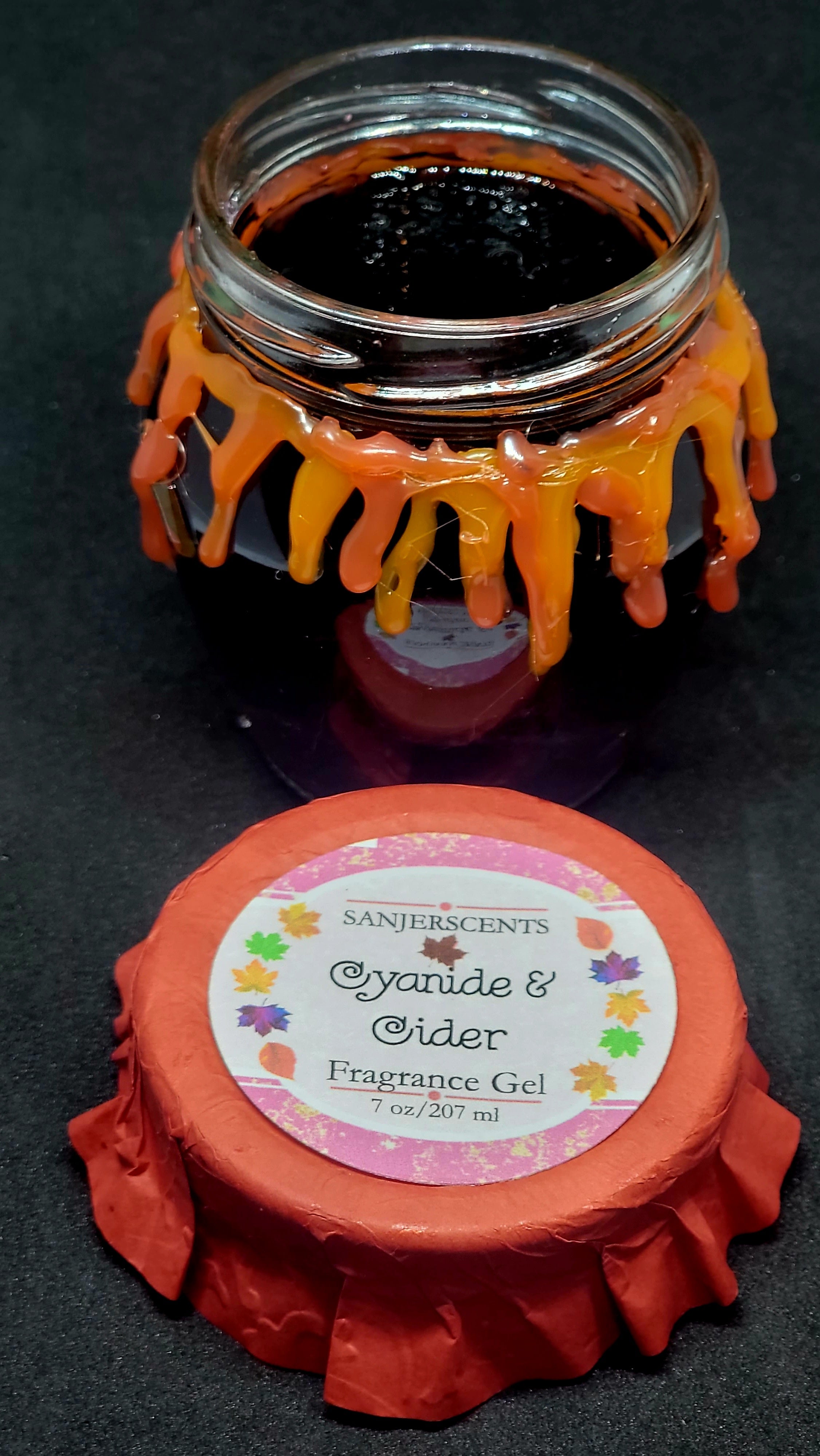 7 oz glass honeypot jar with purple Cyanide & Cider fragrance gel.  Metal screw top lid with red cover